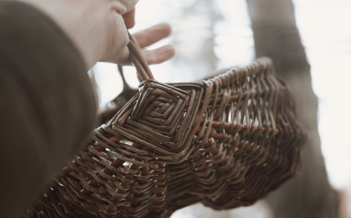 Close-up of a hand-held willow basket with woven diamond detail