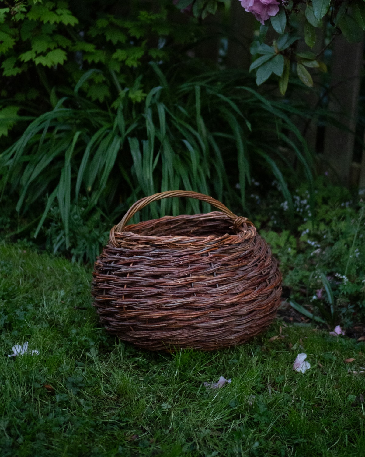 A large sculptural willow basket with a twisted rope effect